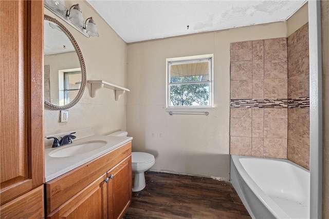 bathroom featuring vanity, wood-type flooring, and toilet