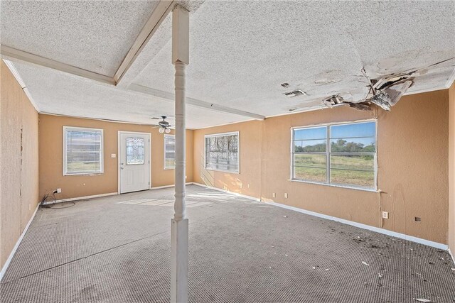 interior space featuring ceiling fan and a textured ceiling