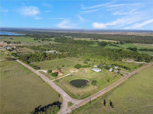 birds eye view of property with a rural view and a water view