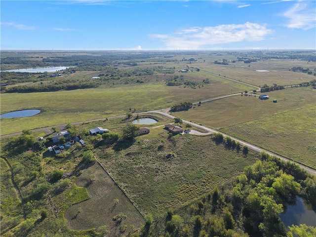 birds eye view of property featuring a water view and a rural view