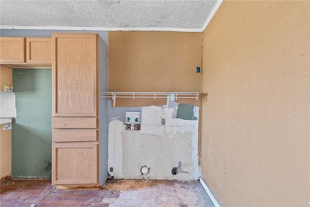 washroom with hookup for a washing machine, a textured ceiling, hookup for a gas dryer, and ornamental molding