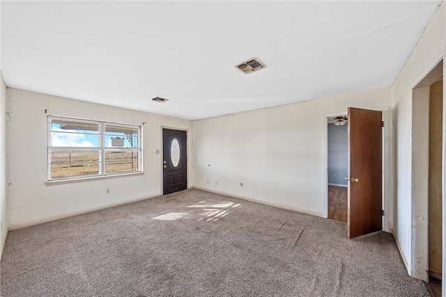 carpeted foyer entrance with ceiling fan