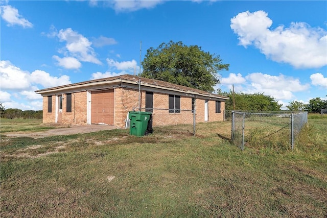 view of side of home with a yard and a garage