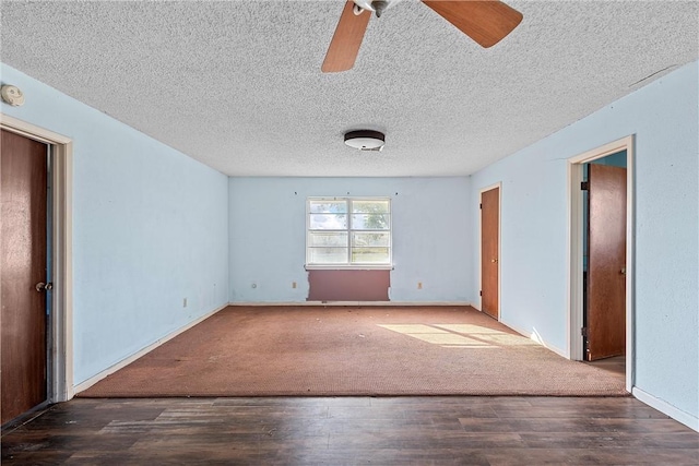 empty room featuring dark hardwood / wood-style floors, ceiling fan, and a textured ceiling