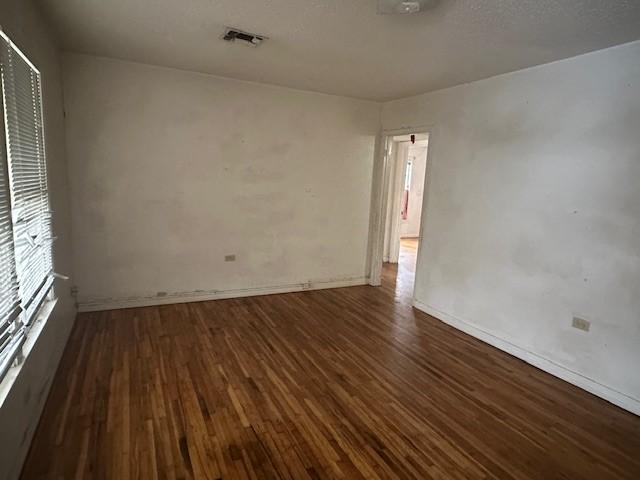 unfurnished room featuring dark wood-type flooring