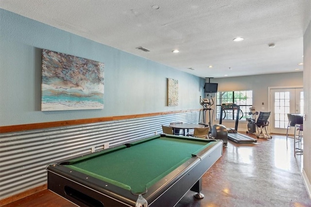 playroom featuring concrete flooring, a textured ceiling, and pool table