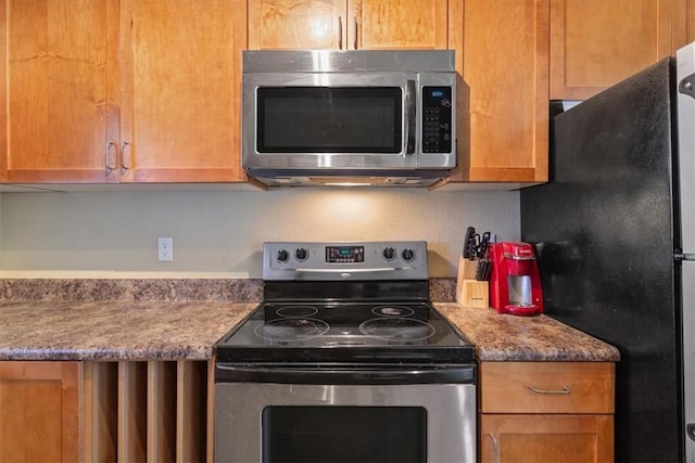 kitchen featuring stone countertops and stainless steel appliances