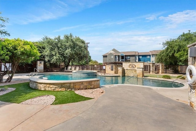 view of swimming pool featuring an in ground hot tub