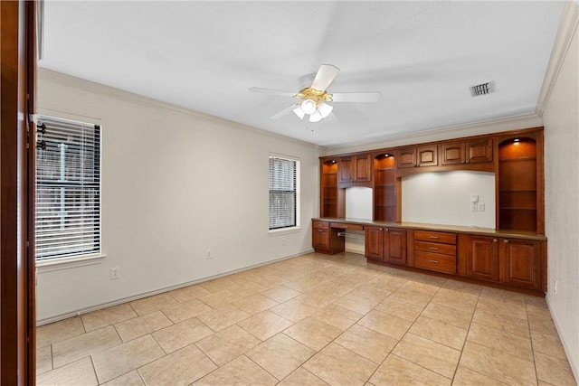 kitchen featuring crown molding, ceiling fan, built in desk, and light tile patterned floors