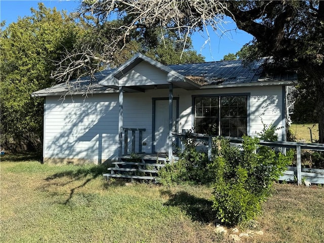 back of property featuring a lawn