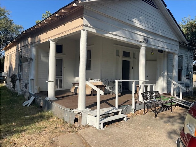 view of front of property with cooling unit and covered porch