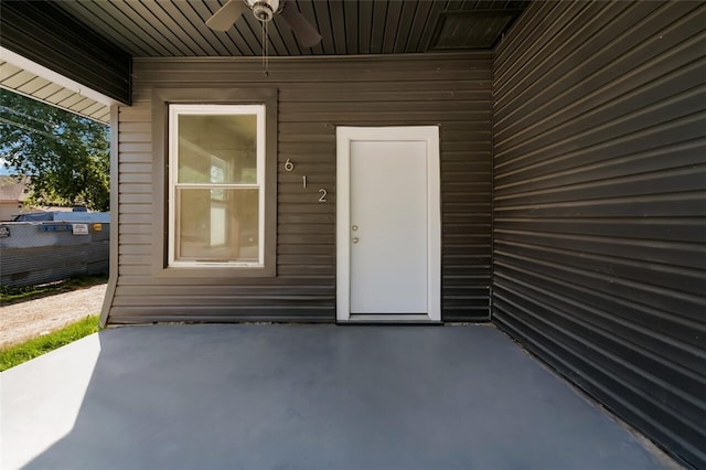 entrance to property featuring ceiling fan and a patio