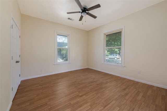 empty room with ceiling fan and hardwood / wood-style floors