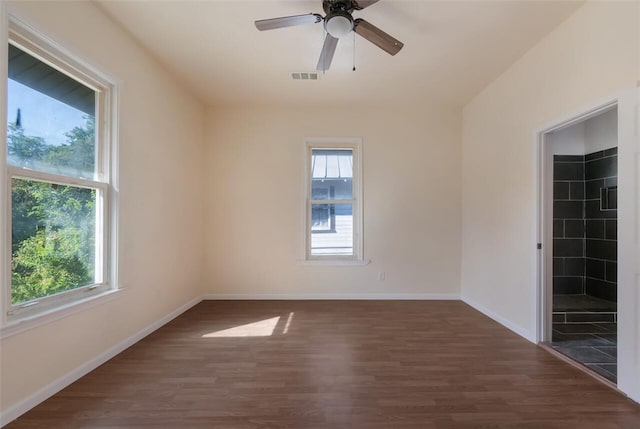 spare room featuring ceiling fan and dark hardwood / wood-style flooring