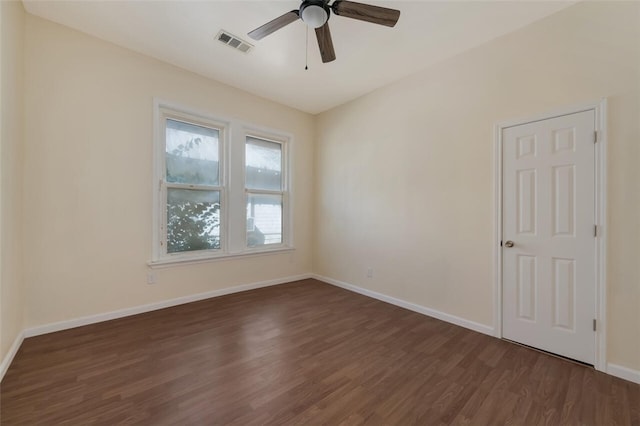 empty room featuring ceiling fan and dark wood-type flooring