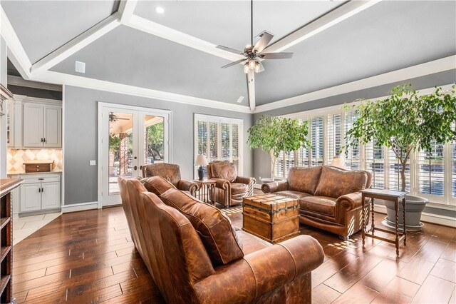 living room featuring french doors, crown molding, vaulted ceiling, hardwood / wood-style flooring, and ceiling fan