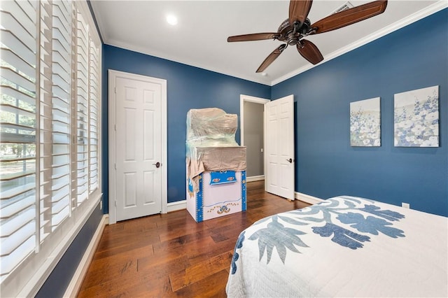 bedroom featuring ornamental molding, ceiling fan, and dark wood-type flooring