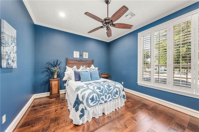 bedroom with ceiling fan, dark hardwood / wood-style flooring, and crown molding