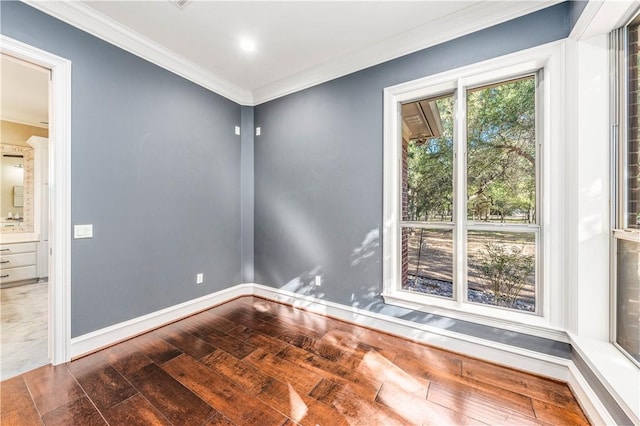 empty room featuring ornamental molding and dark wood-type flooring