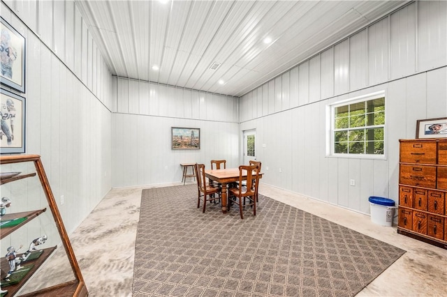 dining space with wood walls