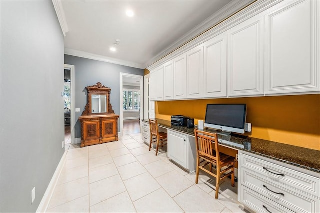 office space with light tile patterned floors, built in desk, and ornamental molding