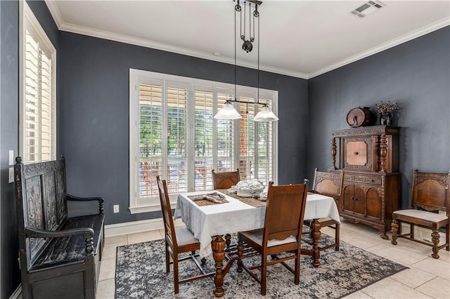 dining area with light tile patterned floors and crown molding