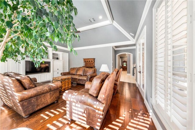 living room featuring crown molding, dark hardwood / wood-style flooring, and vaulted ceiling