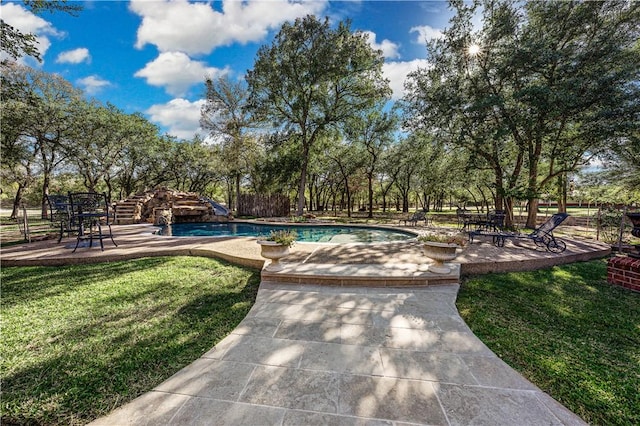 view of swimming pool with a lawn