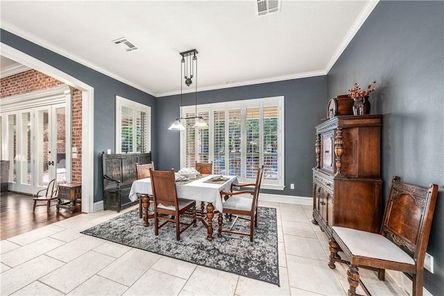 dining space with light tile patterned floors, french doors, and crown molding