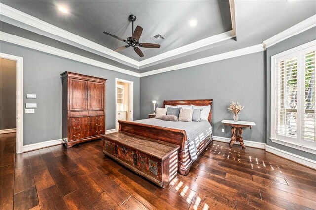 bedroom featuring a tray ceiling, ceiling fan, dark hardwood / wood-style floors, and ornamental molding