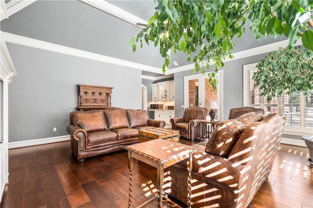 living room featuring beam ceiling, a towering ceiling, dark hardwood / wood-style floors, and ornamental molding