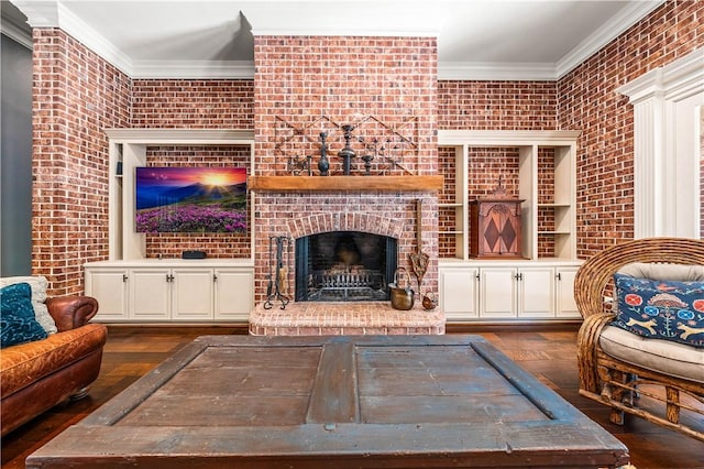 living room featuring crown molding, a fireplace, brick wall, and dark hardwood / wood-style floors