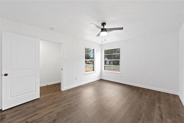 spare room with ceiling fan and dark wood-type flooring