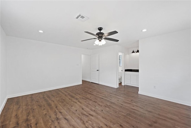 unfurnished living room featuring ceiling fan and dark wood-type flooring