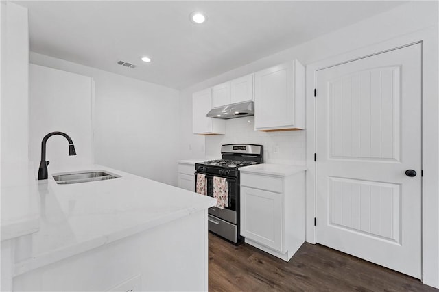 kitchen featuring dark hardwood / wood-style flooring, sink, white cabinetry, and stainless steel gas range