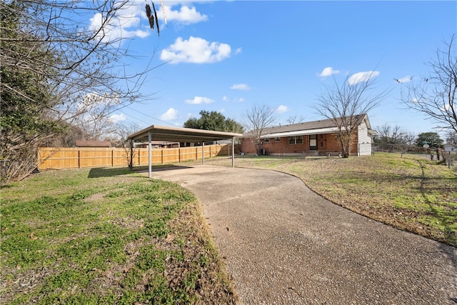 view of front of house featuring a front lawn and a carport