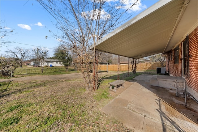 view of yard featuring central AC unit and a patio