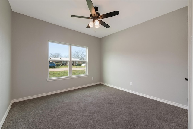 unfurnished room with ceiling fan and dark carpet