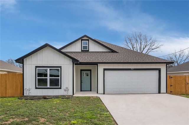 view of front of home featuring board and batten siding, a front lawn, fence, concrete driveway, and an attached garage