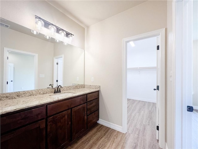 bathroom with vanity and wood-type flooring