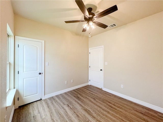 unfurnished bedroom featuring wood-type flooring and ceiling fan