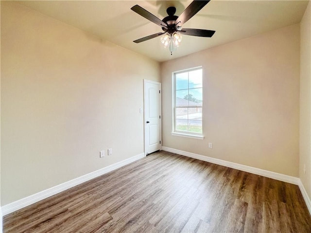 empty room with ceiling fan and wood-type flooring