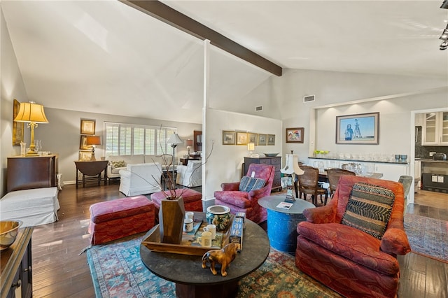 living room with lofted ceiling with beams and dark hardwood / wood-style flooring