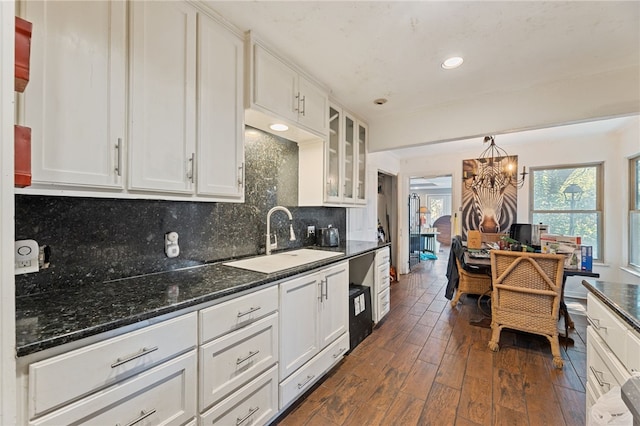 kitchen with dark hardwood / wood-style floors, white cabinetry, sink, and tasteful backsplash