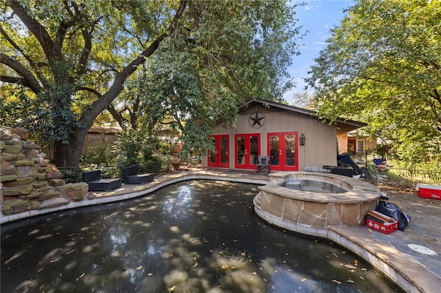 view of pool with french doors