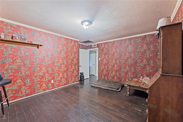 interior space with a textured ceiling, dark hardwood / wood-style flooring, and ornamental molding