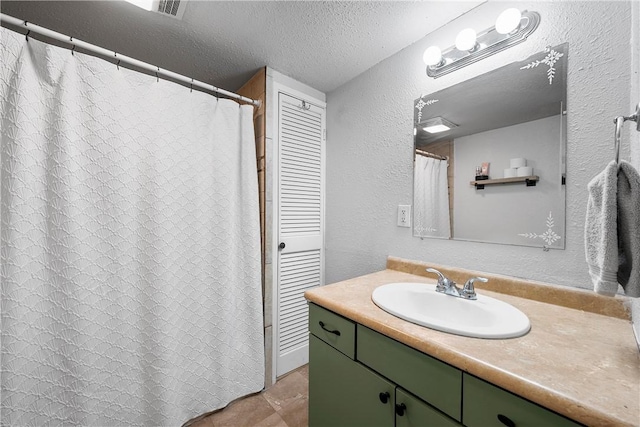 bathroom with vanity and a textured ceiling