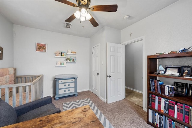 carpeted bedroom featuring ceiling fan and a closet