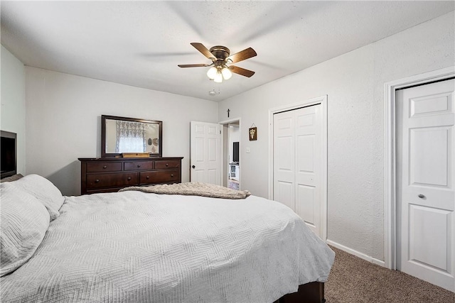 carpeted bedroom with ceiling fan and a closet