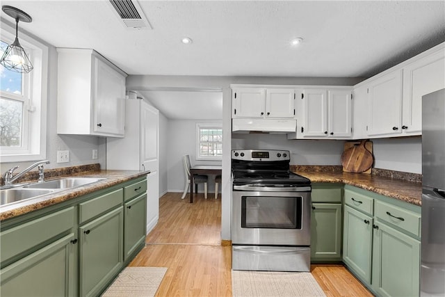 kitchen with sink, green cabinetry, appliances with stainless steel finishes, pendant lighting, and white cabinets